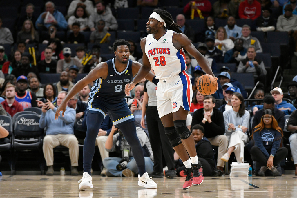 Detroit Pistons forward Isaiah Stewart (28) handles the ball against Memphis Grizzlies forward Jaren Jackson Jr. (8) in the first half of an NBA Cup basketball game Monday, Nov. 3, 2025, in Memphis, Tenn. (AP Photo/Brandon Dill)