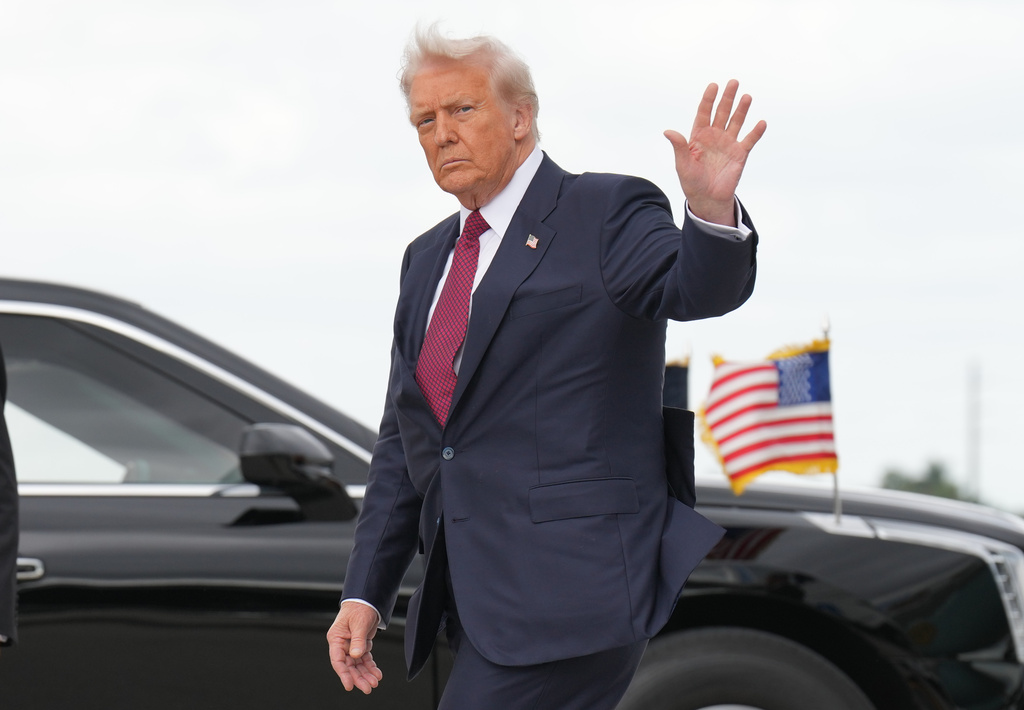 President Donald Trump waves after walking off of Air Force One, Wednesday, Nov. 5, 2025, upon arrival to Miami International Airport, in Miami. (AP Photo/Jacquelyn Martin)