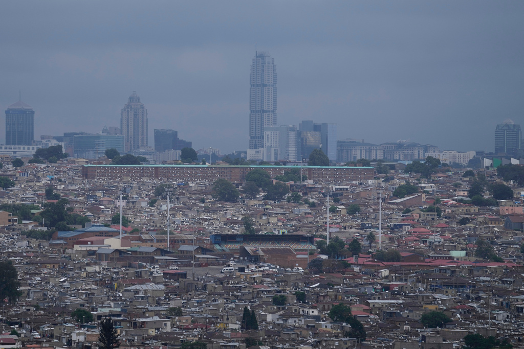 A view of Alexandra township, with the Sandton financial district in the background, in Johannesburg, South Africa, Friday, Nov. 14, 2025. (AP Photo/Themba Hadebe)