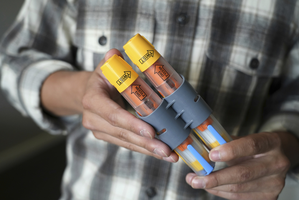 Braxton Kimura shows his EpiPens at home on Wednesday, Aug. 13, 2025, in San Jose, Calif. (AP Photo/Terry Chea)