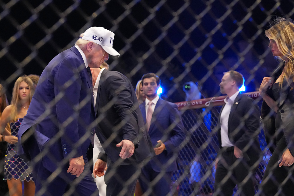 President Donald Trump and first lady Melania Trump stand in the ring at UFC Freedom 250 on the South Lawn of the White House, Monday, June 15, 2026, in Washington. (AP Photo/Alex Brandon)