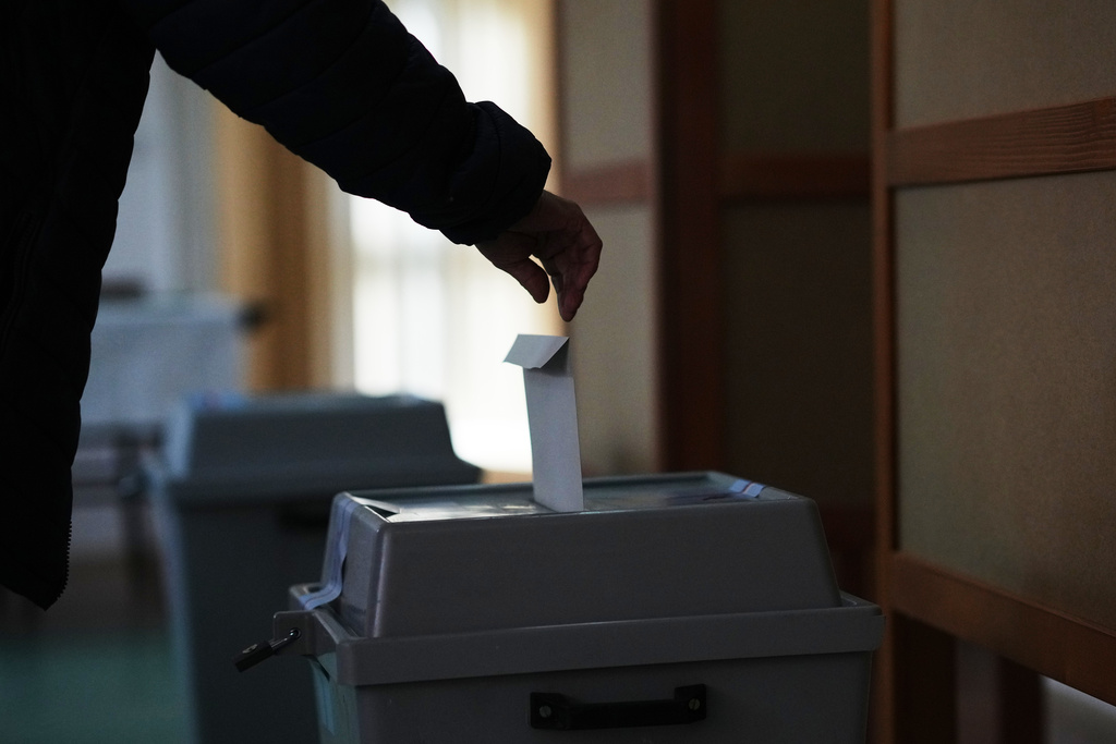 A man casts his ballot for a general election at a polling station in Ostrava, Czech Republic, Friday, Oct. 3, 2025. (AP Photo/Petr David Josek)