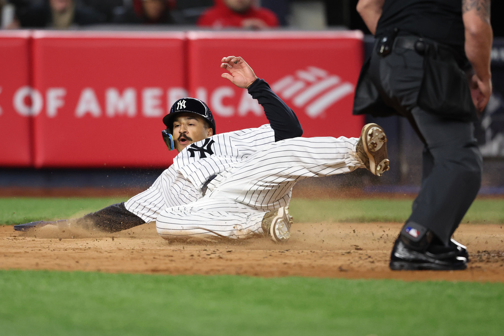 New York Yankees' Trent Grisham slides home to score during the sixth inning of a baseball game against the Miami Marlins, Saturday, April 4, 2026, in New York. (AP Photo/Heather Khalifa)