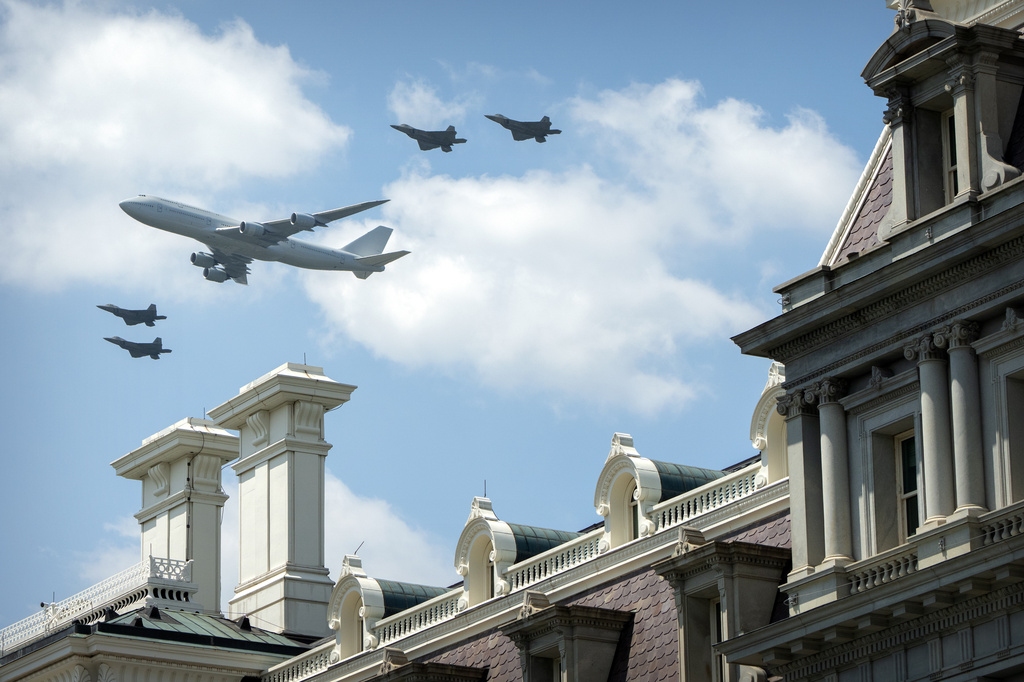 Military aircraft fly over the National Mall near the Eisenhower Executive Office Building on the White House complex, Friday, July 3, 2026, in Washington. (AP Photo/Mark Schiefelbein)
