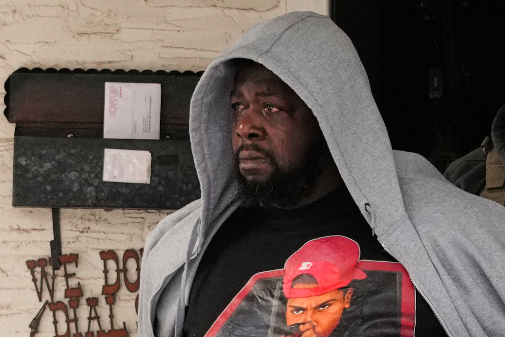 ADDS IDENTIFICATION: Garrison Gibson becomes emotional as he is arrested by federal immigration officers Sunday, Jan. 11, 2026, in Minneapolis. (AP Photo/John Locher)