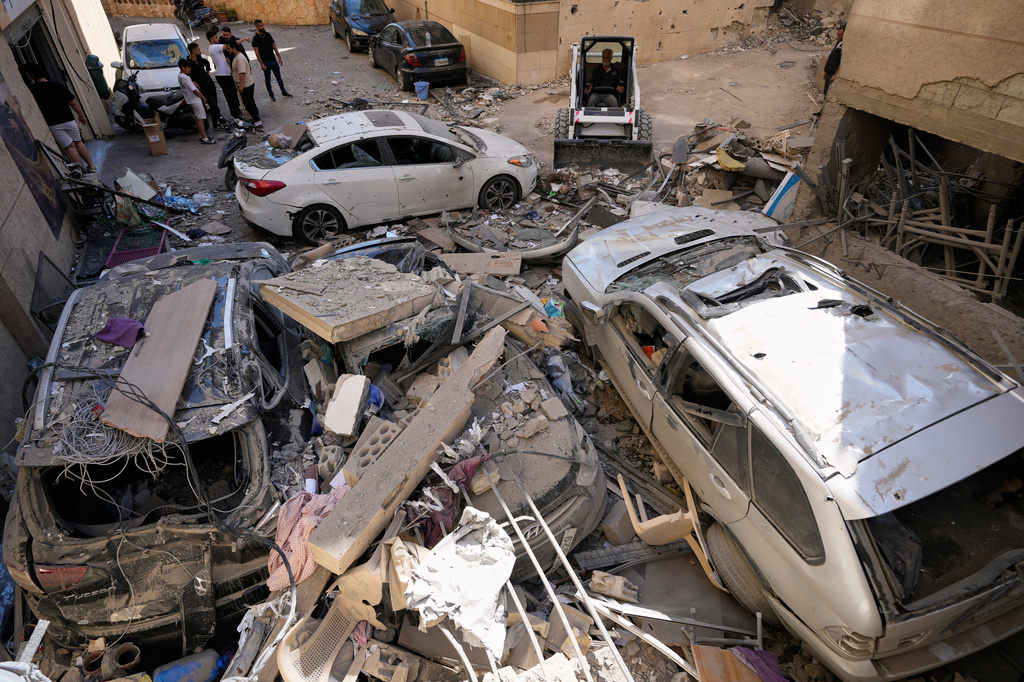 A worker uses a skid loader as he removes rubble at the site of a destroyed apartment that was hit in an Israeli airstrike in Choueifat town, southern Beirut, Lebanon, Thursday, May 28, 2026. (AP Photo/Hussein Malla)