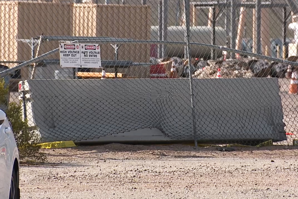 This photo provided by KTNV shows damage to a fence outside a power substation, where authorities say they are investigating a car collision, on Thursday, Feb. 19, 2026, in Boulder City, Nevada. (KTNV via AP)