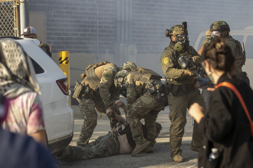 Immigration and Customs Enforcement officers arrest a protester at the ICE facility in Broadview, Ill., Friday, Sept. 19, 2025. (Zubaer Khan /Chicago Sun-Times via AP)