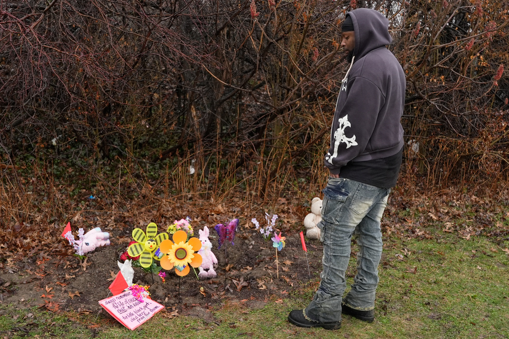 DeShaun Chatman, the father of one of the two girls whose bodies found earlier in this week, Mila Chatman, stands at the site where there is now a memorial to the girls, in Cleveland, Thursday, March 5, 2026. (AP Photo/Sue Ogrocki)