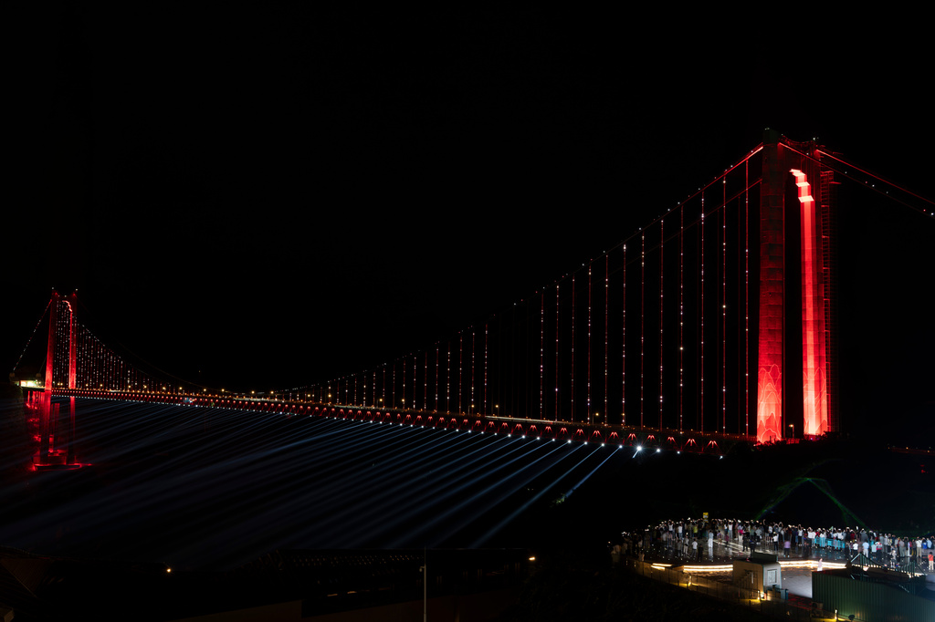 Visitors look at a light show on Huajiang Grand Canyon Bridge, considered to be the world’s highest bridge, in Anshun in southwestern China's Guizhou province on Thursday, May 28, 2026. (AP Photo/Ng Han Guan)