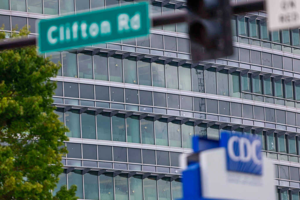The notable bullet marks on the windows of the Centers for Disease Control and Prevention headquarters are visible on Sunday Aug. 10, 2025. (Miguel Martinez/Atlanta Journal-Constitution via AP)
