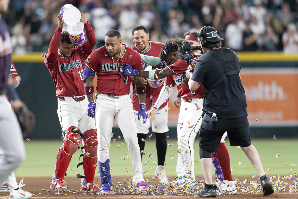 Arizona Diamondbacks teammates celebrate Ketel Marte's (4) game-winning home run in the 10th inning of a baseball game against the Atlanta Braves, Sunday, April 5, 2026, in Phoenix. (AP Photo/Rebecca Noble)