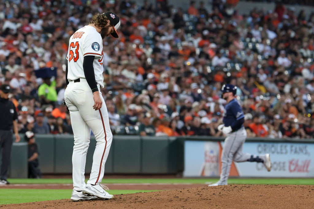 Baltimore Orioles pitcher Brandon Young, foreground, looks down after surrendering a home run to Tampa Bay Rays' Liam Hicks during the second inning of baseball game in Baltimore, Saturday, Aug. 22, 2026. (AP Photo/Terrance Williams)