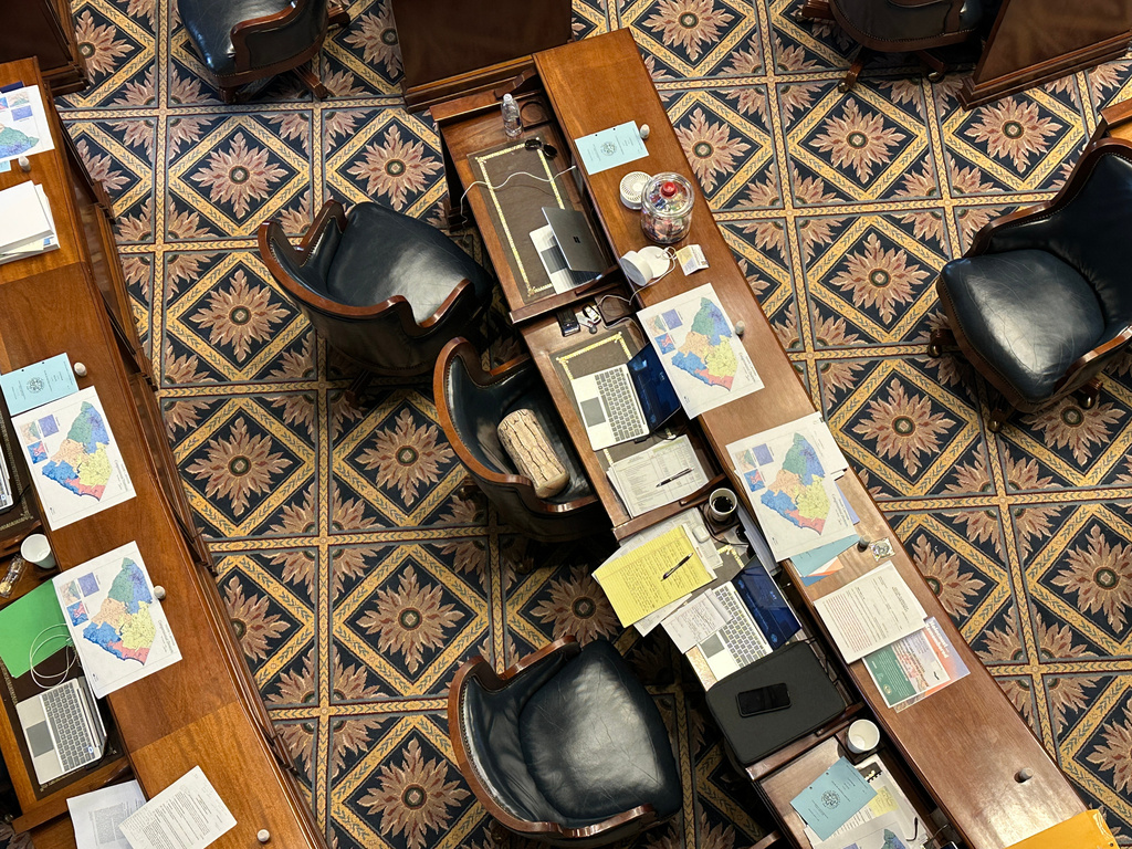 A new suggested map for South Carolina congressional districts sits on senators' desks, Thursday, May 21, 2026, in Columbia, S.C. (AP Photo/Jeffrey Collins)
