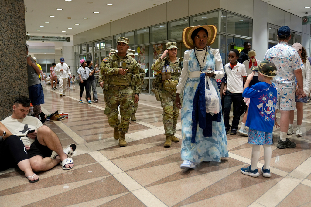 People take cover in the Ronald Reagan Federal Building after evacuating the National Mall due to weather while attending Independence Day events honoring the nation's 250th anniversary, Saturday, July 4, 2026, in Washington. (AP Photo/Pablo Martinez Monsivais)