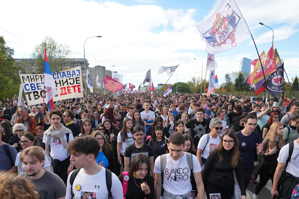 People gather, among them students, to walk on the street towards the northern city of Novi Sad, for a huge rally on Nov. 1 marking the first anniversary of a train station disaster that killed 16 people, in Belgrade, Serbia, Thursday, Oct. 30, 2025. (AP Photo/Darko Vojinovic)
