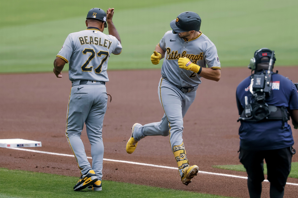 Pittsburgh Pirates' Spencer Horwitz, center, is greeted by third base coach Tony Beasley, left after hitting a leadoff home run against the Atlanta Braves during the first inning of a baseball game, Sunday, June 7, 2026, in Atlanta. (AP Photo/Erik S. Lesser)
