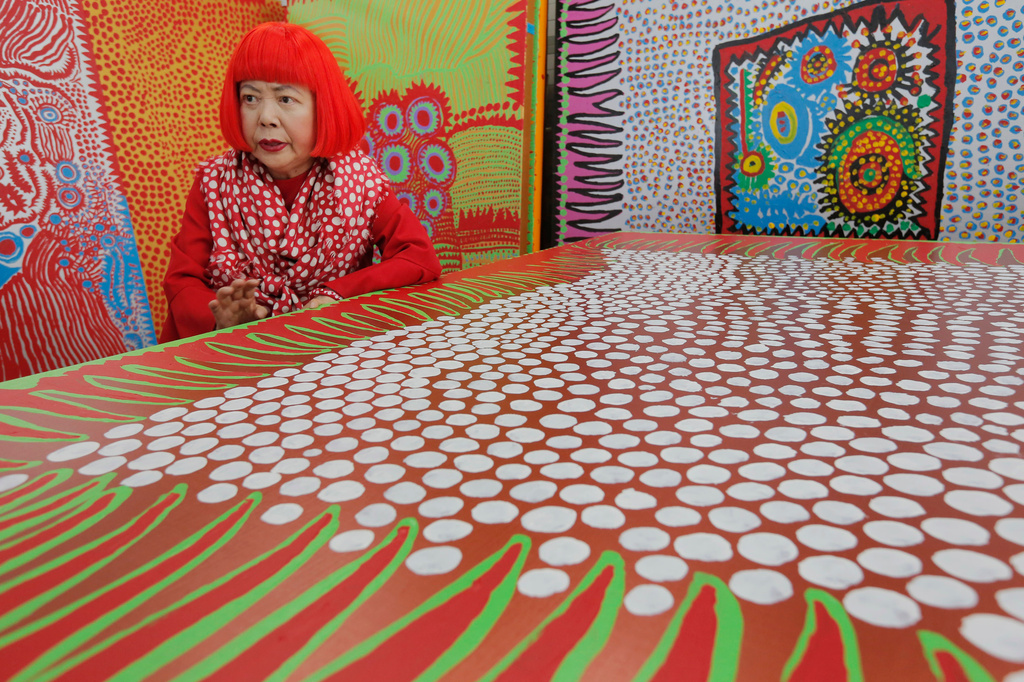 FILE - Japanese avant-garde artist Yayoi Kusama speaks during an interview at her studio, filled with wall-sized paintings throbbing with her repetitive dots, in Tokyo on Aug. 1, 2012. (AP Photo/Itsuo Inouye, File)