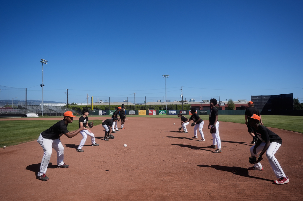 Players from the McClymonds High School baseball team practice fielding at Raimondi Field Wednesday, April 29, 2026, in Oakland, Calif. (AP Photo/Jeff Chiu)