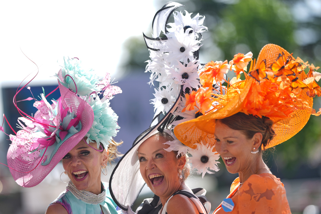 Racegoers pose for photographers as they arrive on the second day of the Royal Ascot horse race meeting in Ascot, England, Wednesday, June 17, 2026.(AP Photo/Alastair Grant)