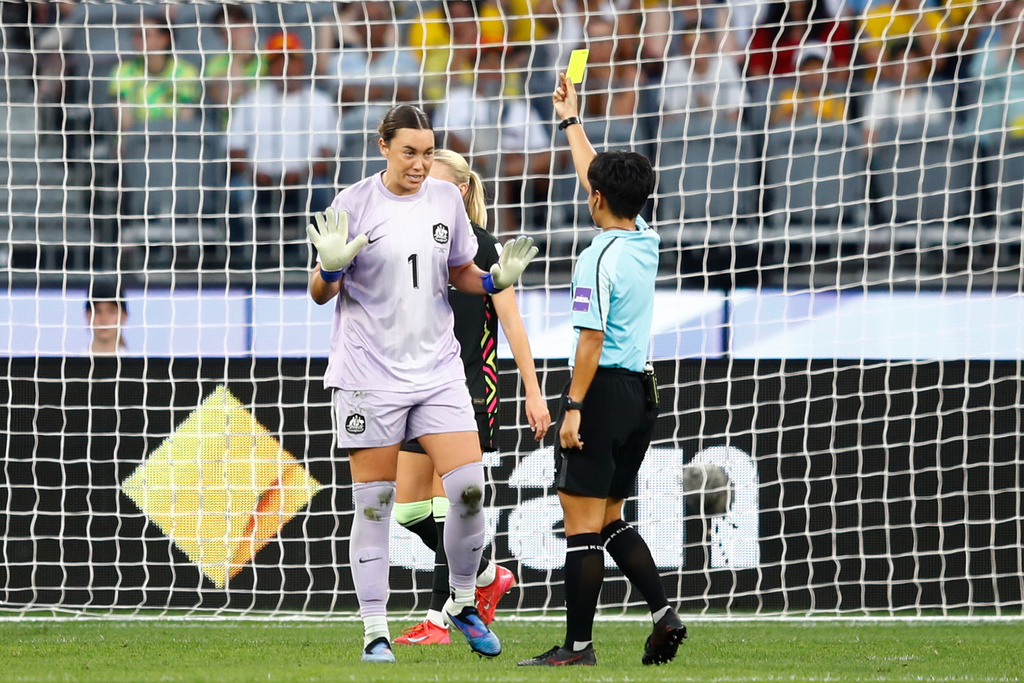 Australia's goalkeeper Mackenzie Arnold, left, reacts as she receives a yellow card from referee Supiree Testhomy during the Women's Asian Cup semifinal soccer match between China and Australia in Perth, Australia, Tuesday, March 17, 2026. (AP Photo/Gary Day)