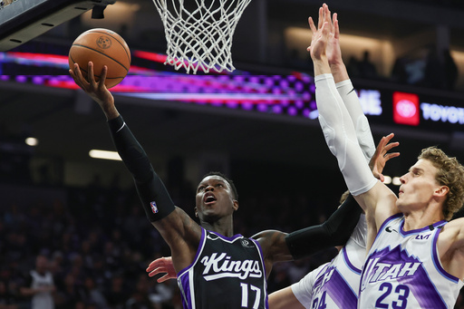 Sacramento Kings guard Dennis Schröder (17) attempts a layup around Utah Jazz center Walker Kessler, center, and forward Lauri Markkanen (23) during the first half of an NBA basketball game Friday, Oct. 24, 2025, in Sacramento, Calif. (AP Photo/Sara Nevis) Sacramento Kings guard Dennis Schröder (17) attempts a layup around Utah Jazz center Walker Kessler, center, and forward Lauri Markkanen (23) during the first half of an NBA basketball game Friday, Oct. 24, 2025, in Sacramento, Calif. (AP Photo/Sara Nevis)