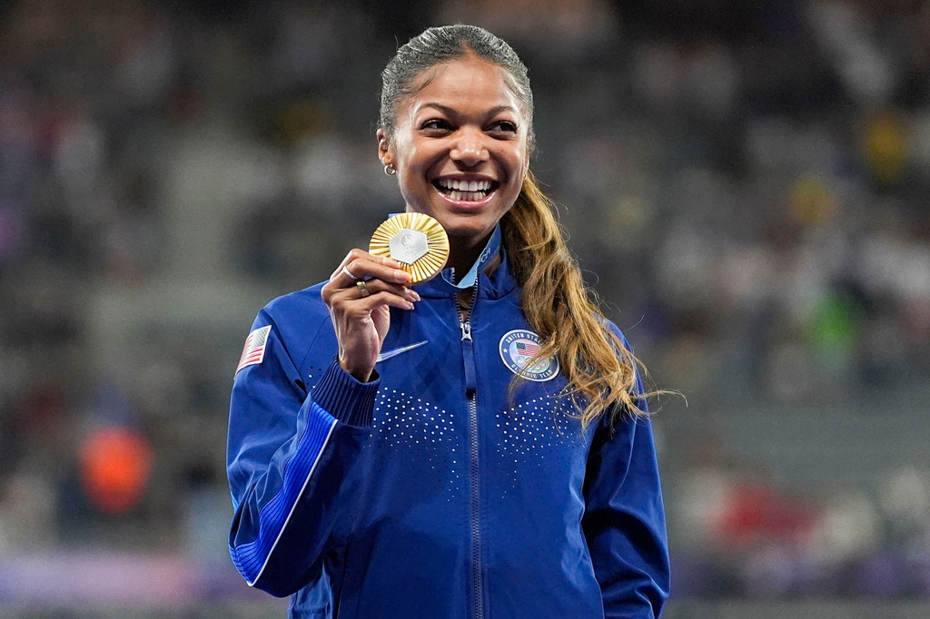 FILE - Gold medalist Gabby Thomas stands on the podium after the women's 200-meter at the 2024 Summer Olympics, Wednesday, Aug. 7, 2024, in Saint-Denis, France. (AP Photo/Matthias Schrade, File)