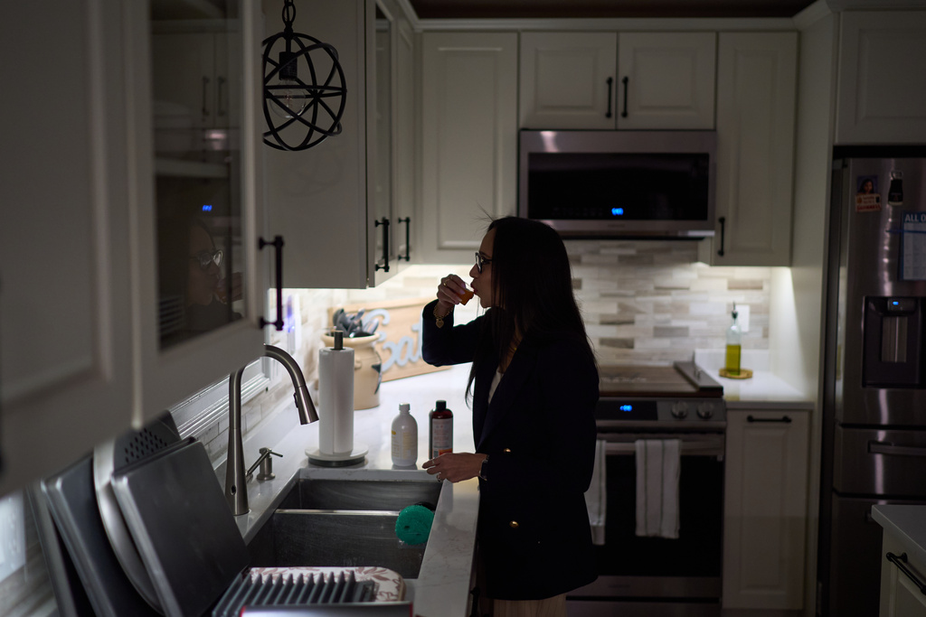 Ruth Wilson, whose lupus took six years to diagnose, starts her morning ritual of supplements and prescription medications before going to work early Monday, Jan. 13, 2025, in Littleton, Mass. (AP Photo/David Goldman)
