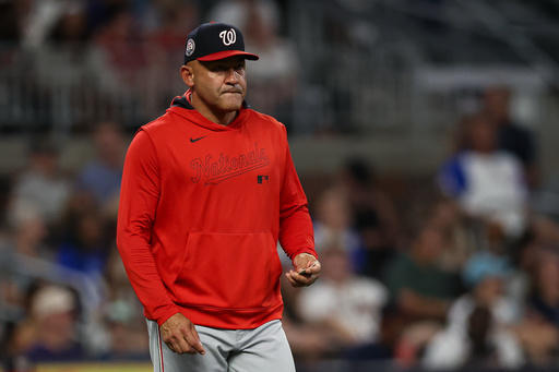 FILE - Washington Nationals interim manager Miguel Cairo walks out to the mound to make a pitching change in the seventh inning of a baseball game against the Atlanta Braves, Tuesday, Sept. 23, 2025, in Atlanta. (AP Photo/Colin Hubbard, File) FILE - Washington Nationals interim manager Miguel Cairo walks out to the mound to make a pitching change in the seventh inning of a baseball game against the Atlanta Braves, Tuesday, Sept. 23, 2025, in Atlanta. (AP Photo/Colin Hubbard, File)