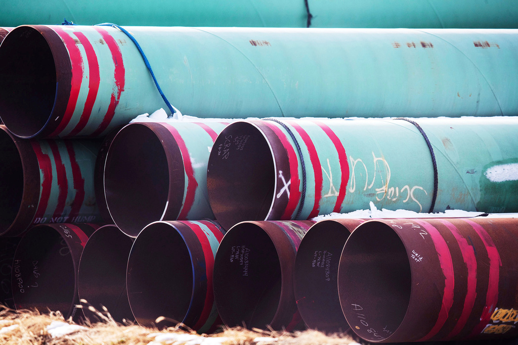 FILE - Pipes meant for the Keystone XL pipeline are stored in a field near Dorchester, Neb., Dec. 18, 2020. (Chris Machian /Omaha World-Herald via AP, File)