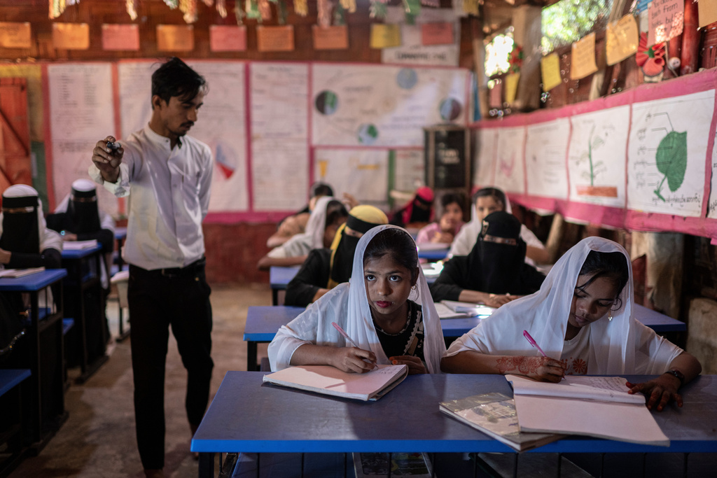 Rohingya refugee girls attend a class at their school in the Rohingya refugee camp in Cox's Bazar, Bangladesh, Wednesday, Nov. 26, 2025. (AP Photo/Mahmud Hossain Opu)