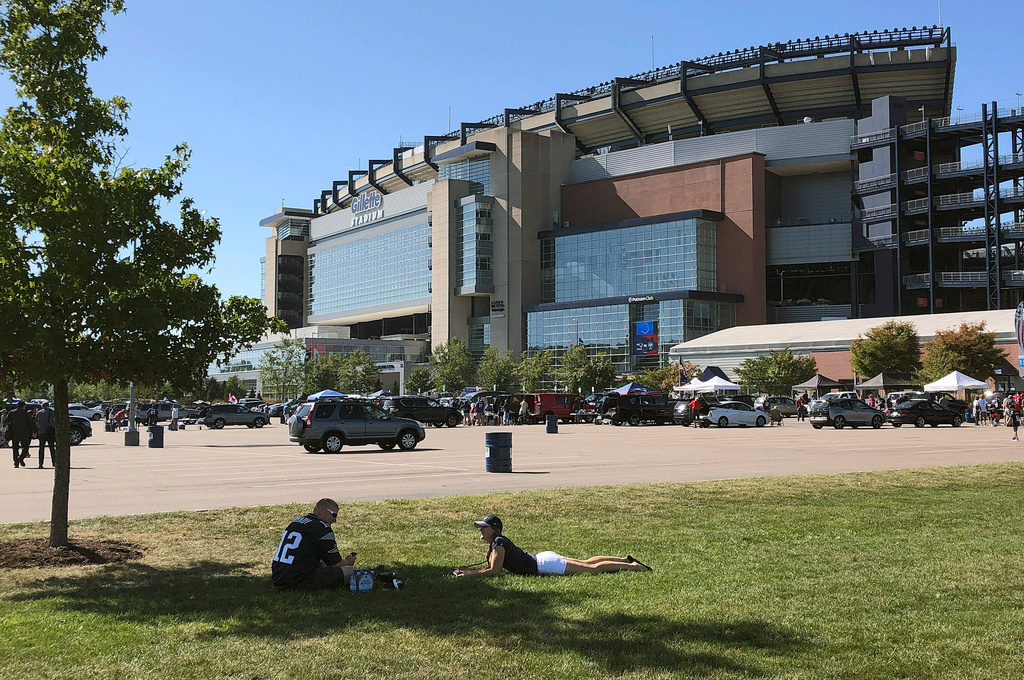 FILE - Fans spend time tailgating in the parking lot of Gillette Stadium before an NFL football game between the New England Patriots and the New York Jets, Sunday, Sept. 22, 2019, in Foxborough, Mass. (AP Photo/Bill Sikes, File)