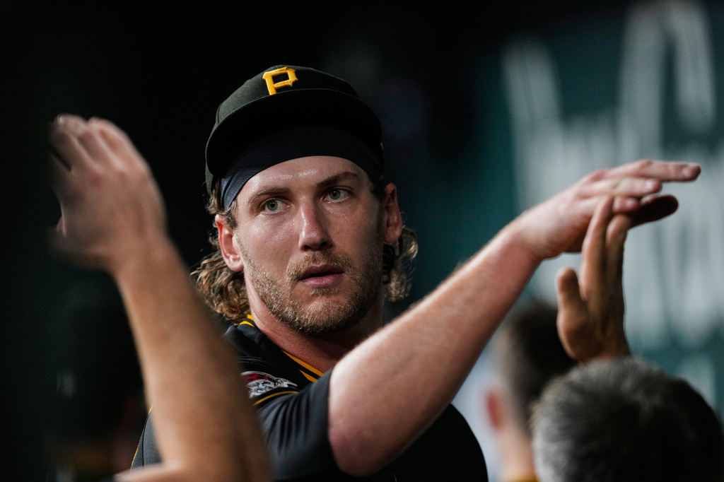 Pittsburgh Pirates pitcher Braxton Ashcraft hi-fives with teammates in the dugout after working against the Texas Rangers in the seventh inning of a baseball game Wednesday, April 22, 2026, in Arlington, Texas. (AP Photo/Tony Gutierrez)