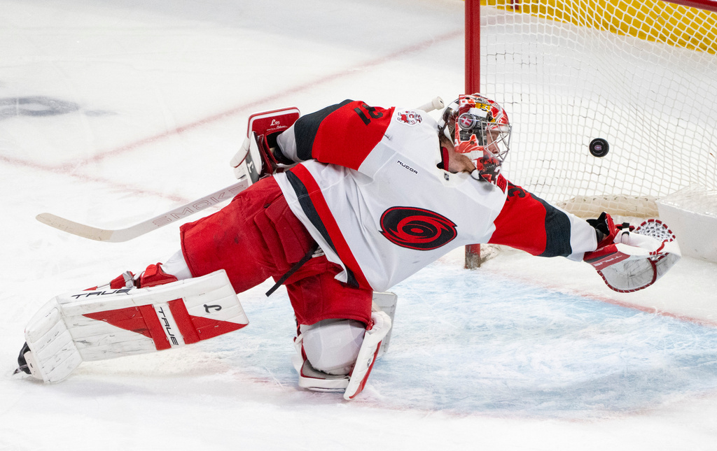 Carolina Hurricanes goaltender Frederik Andersen (31) is scored on by Montreal Canadiens' Cole Caufield during the second period of an NHL hockey game in Montreal on Tuesday, March 24, 2026. (Christinne Muschi/The Canadian Press via AP)