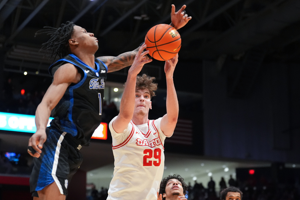 Dayton's Amael L'etang (29), center, and Saint Louis' Quentin Jones (1), left, compete for a rebound during the first half of an NCAA college basketball game, Tuesday, Feb. 24, 2026, in Dayton, Ohio. (AP Photo/Kareem Elgazzar)