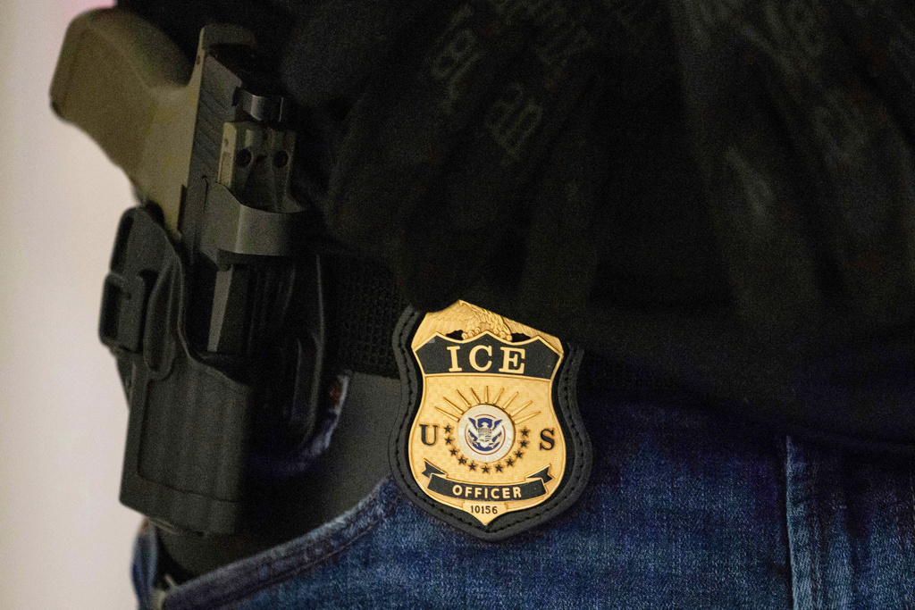 FILE - A federal agent wears an Immigration and Customs Enforcement badge at the immigration court at Jacob K. Javits Federal Building in New York, on Monday, June 9, 2025. (AP Photo/Yuki Iwamura, File)