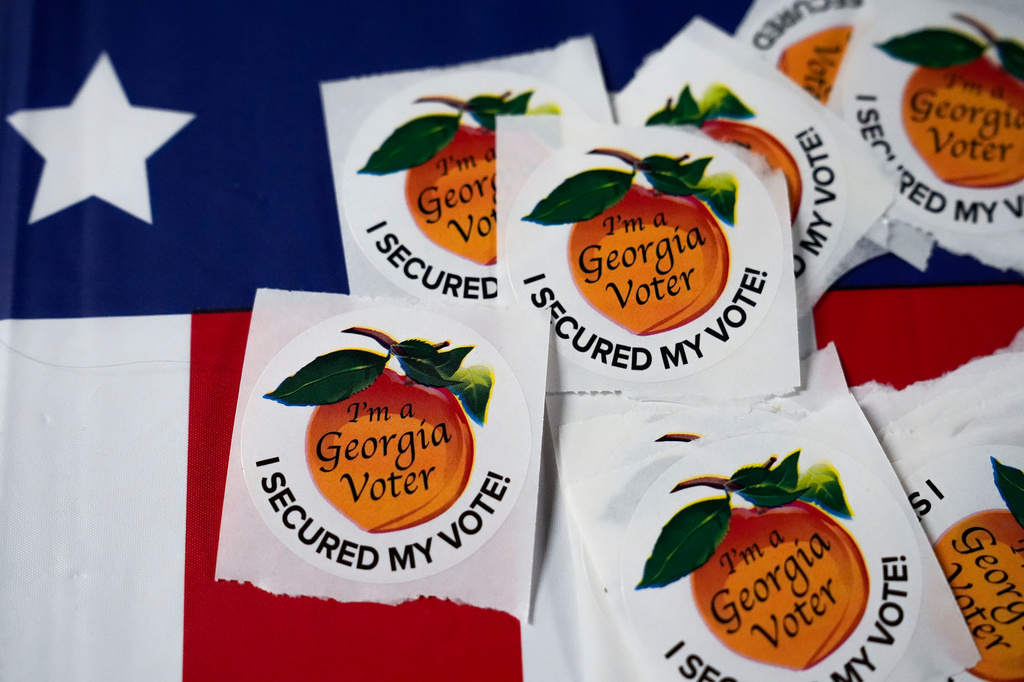 FILE - Stickers sit on a table inside a polling place, Nov. 5, 2024, in Atlanta. (AP Photo/Brynn Anderson, File)