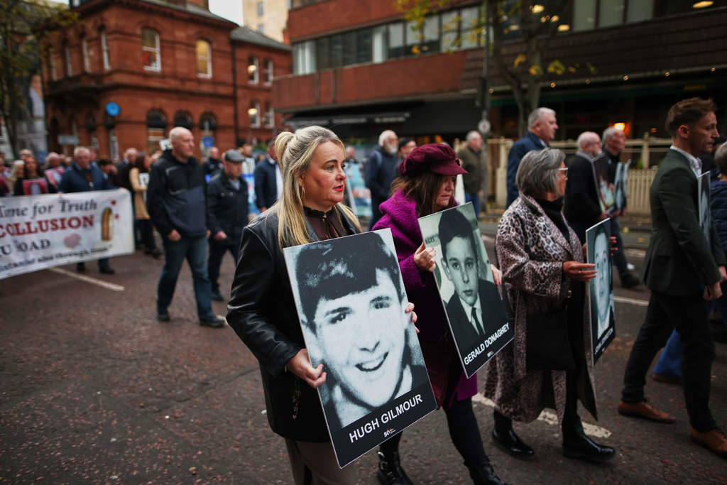 Relatives and supporters of the victims of the 1972 Bloody Sunday massacre march to Belfast Crown Court ahead of the verdict on the trial of a British soldier identified only as Soldier F, Belfast, in Northern Ireland, Thursday, Oct. 23, 2025. (AP Photo/Peter Morrison)