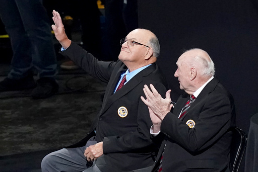Former Pittsburgh Penguins head coach Scotty Bowman, left, waves next to former general manager and head coach Eddie Johnston as he's introduced during a ceremony inducting him into the 2025 Pittsburgh Penguins Hall of Fame class before an NHL hockey game between the Columbus Blue Jackets and the Pittsburgh Penguins, Saturday, Oct. 25, 2025, in Pittsburgh. (AP Photo/Matt Freed) Former Pittsburgh Penguins head coach Scotty Bowman, left, waves next to former general manager and head coach Eddie Johnston as he's introduced during a ceremony inducting him into the 2025 Pittsburgh Penguins Hall of Fame class before an NHL hockey game between the Columbus Blue Jackets and the Pittsburgh Penguins, Saturday, Oct. 25, 2025, in Pittsburgh. (AP Photo/Matt Freed)