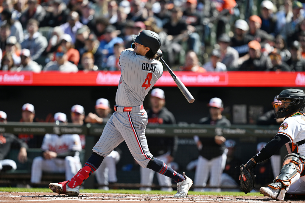 Minnesota Twins Tristan Gray follows through on a three run double against the Baltimore Orioles during the second inning of a baseball game, Sunday, March 29, 2026 in Baltimore. Gray was tagged out trying to reach third. (AP Photo/Gail Burton)