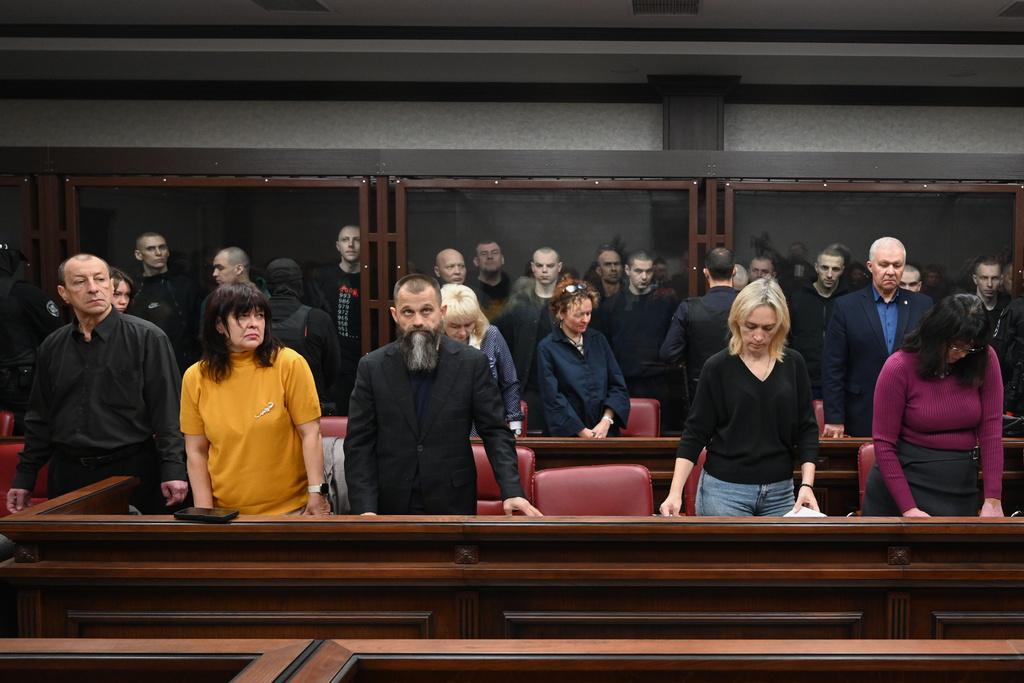 Lawyers of Ukrainian soldiers of the Aidar battalion captured by Russia during fighting in Ukraine stand in front of the defendants' cage during a hearing at the Southern District Military Court in Rostov-on-Don, Russia, Friday, Oct. 17, 2025. (AP Photo)