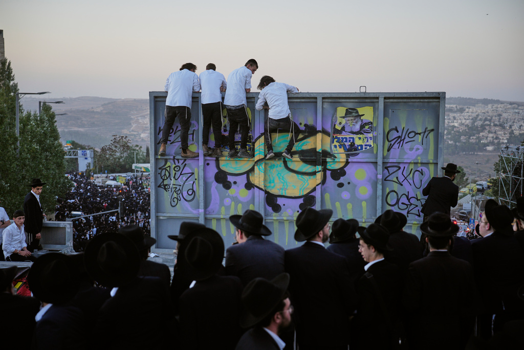 Ultra-Orthodox Jewish men attend a rally against plans to force them to serve in the Israeli military, in Jerusalem, Thursday, Oct. 30, 2025. (AP Photo/Ohad Zwigenberg)