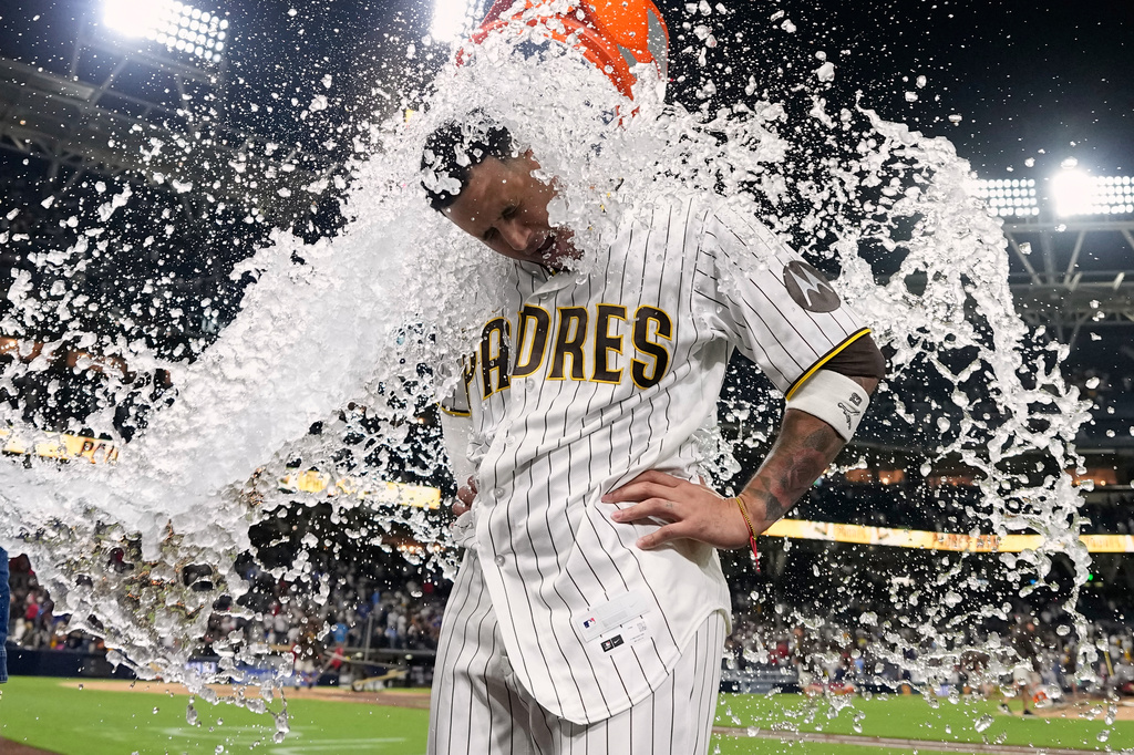 San Diego Padres' Manny Machado is doused after hitting a walk off single to defeat the Atlanta Braves during the tenth inning of a baseball game Tuesday, June 23, 2026, in San Diego. (AP Photo/Gregory Bull)