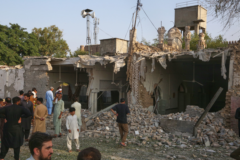 Local residents look at damage at the site following a bomb explosion at a mosque in Kohat, in northwestern Pakistan, Friday, Sept. 18, 2026. (AP Photo/Muhammad Sajjad)