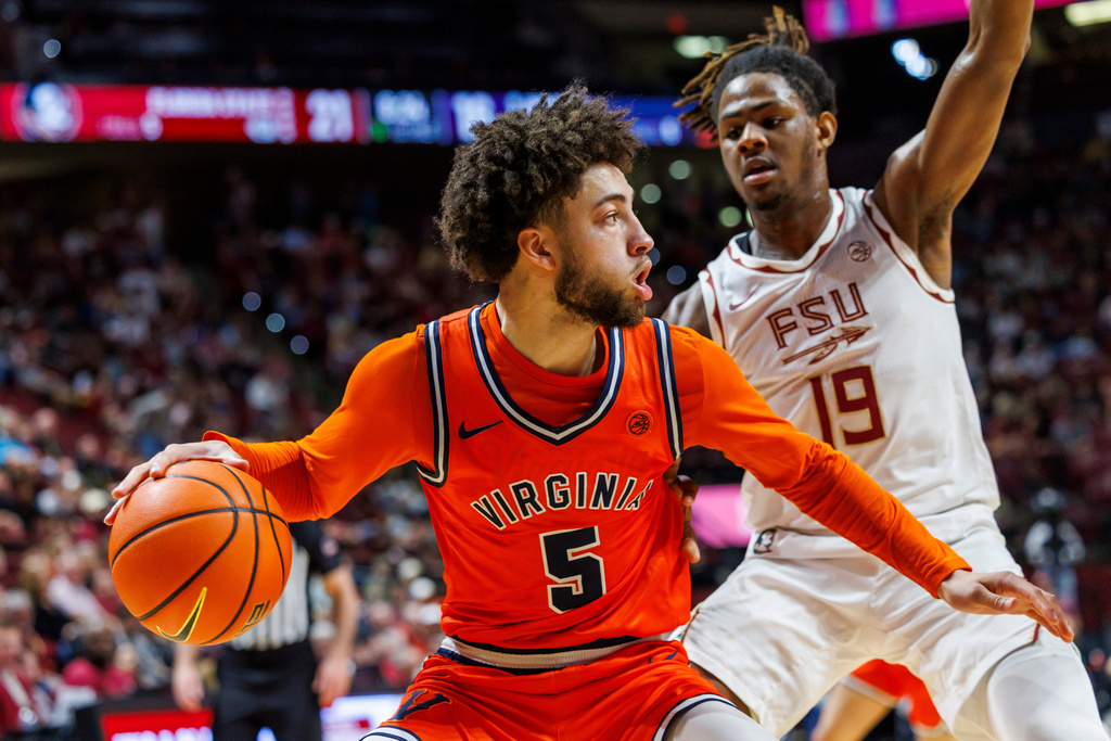 Virginia guard Sam Lewis (5) tries to drive around Florida State forward AJ Swinton (19) during the first half of an NCAA college basketball game, Tuesday, Feb. 10, 2026, in Tallahassee, Fla. (AP Photo/Colin Hackley)