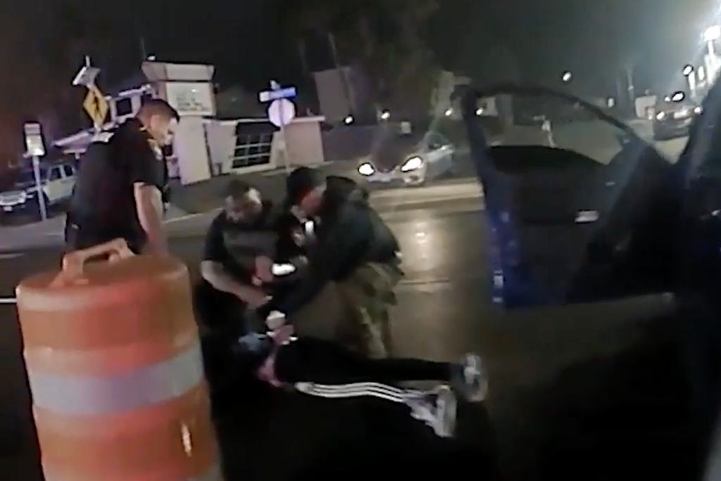 In this image from video provided by the Texas Department of Public Safety, law enforcement officials surround Ruben Ray Martinez after he was shot by Homeland Security Investigations Special Agent Jack Stevens and pulled from his vehicle at a roadblock in South Padre Island, Texas, on Saturday, March 15, 2025. (Officer Miguel Leal/Texas Department of Public Safety via AP)