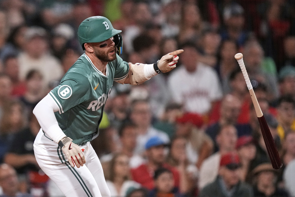 Boston Red Sox's Trevor Story tosses the bat on his single in the fifth inning of a baseball game against the Miami Marlins at Fenway Park, Friday, Aug. 15, 2025, in Boston. (AP Photo/Charles Krupa)