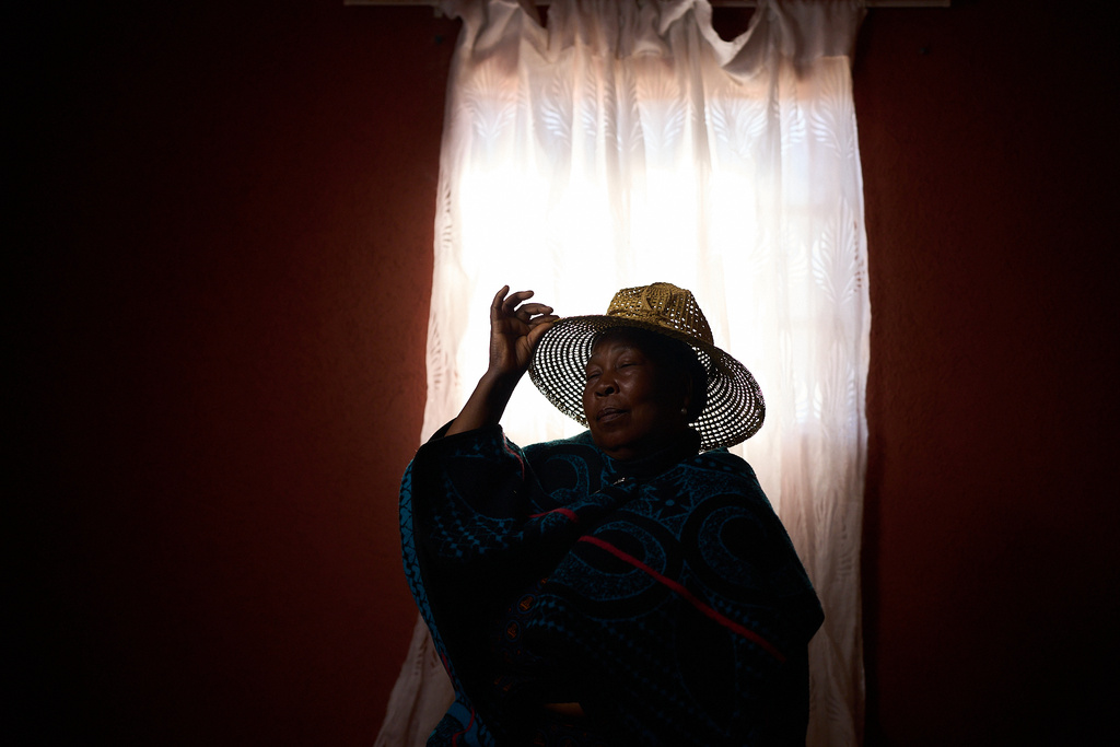 Mamohlalefi Matsoele, who is HIV-positive, poses for a portrait inside her home in Ha Koloboi, Lesotho, Saturday, July 12, 2025. Matsoele makes a living selling poultry and cares for three children, two grandchildren and one orphan whose parents died from AIDS. She fears the country will fall behind in its progress to fight what was one of the deadliest epidemics in modern history. (AP Photo/Bram Janssen)