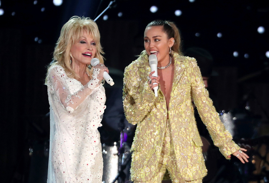 FILE - Dolly Parton, left, and Miley Cyrus perform "Jolene" at the 61st annual Grammy Awards in Los Angeles on Feb. 10, 2019. (Photo by Matt Sayles/Invision/AP, File)