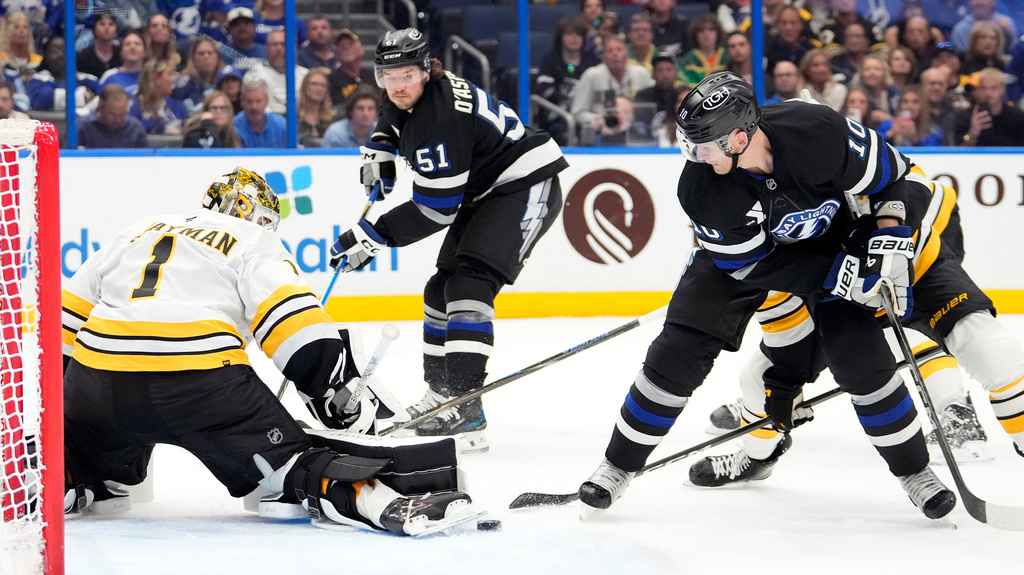Boston Bruins goaltender Jeremy Swayman (1) makes a pad save on a shot by Tampa Bay Lightning right wing Corey Perry (10) during the second period of an NHL hockey game Saturday, April 4, 2026, in Tampa, Fla. (AP Photo/Chris O'Meara)